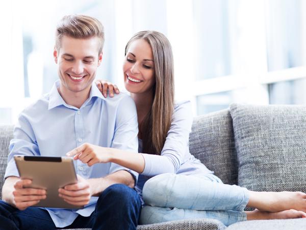 Couple using digital tablet