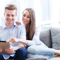 Couple using digital tablet