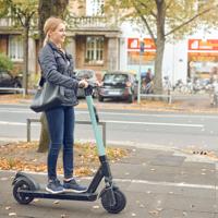 Woman riding electric scooter