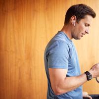Man using smart treadmill and phone