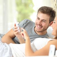 Happy couple using smartphone