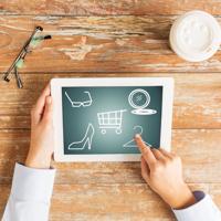 Woman using tablet for online fashion shopping