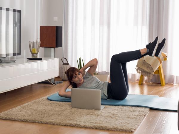 Woman doing online workout at home