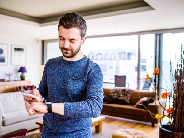Man working from home with smartwatch