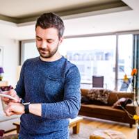 Man working from home with smartwatch