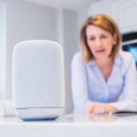 Woman using smart speaker