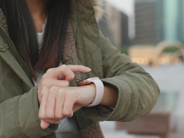 Woman using smartwatch outdoors